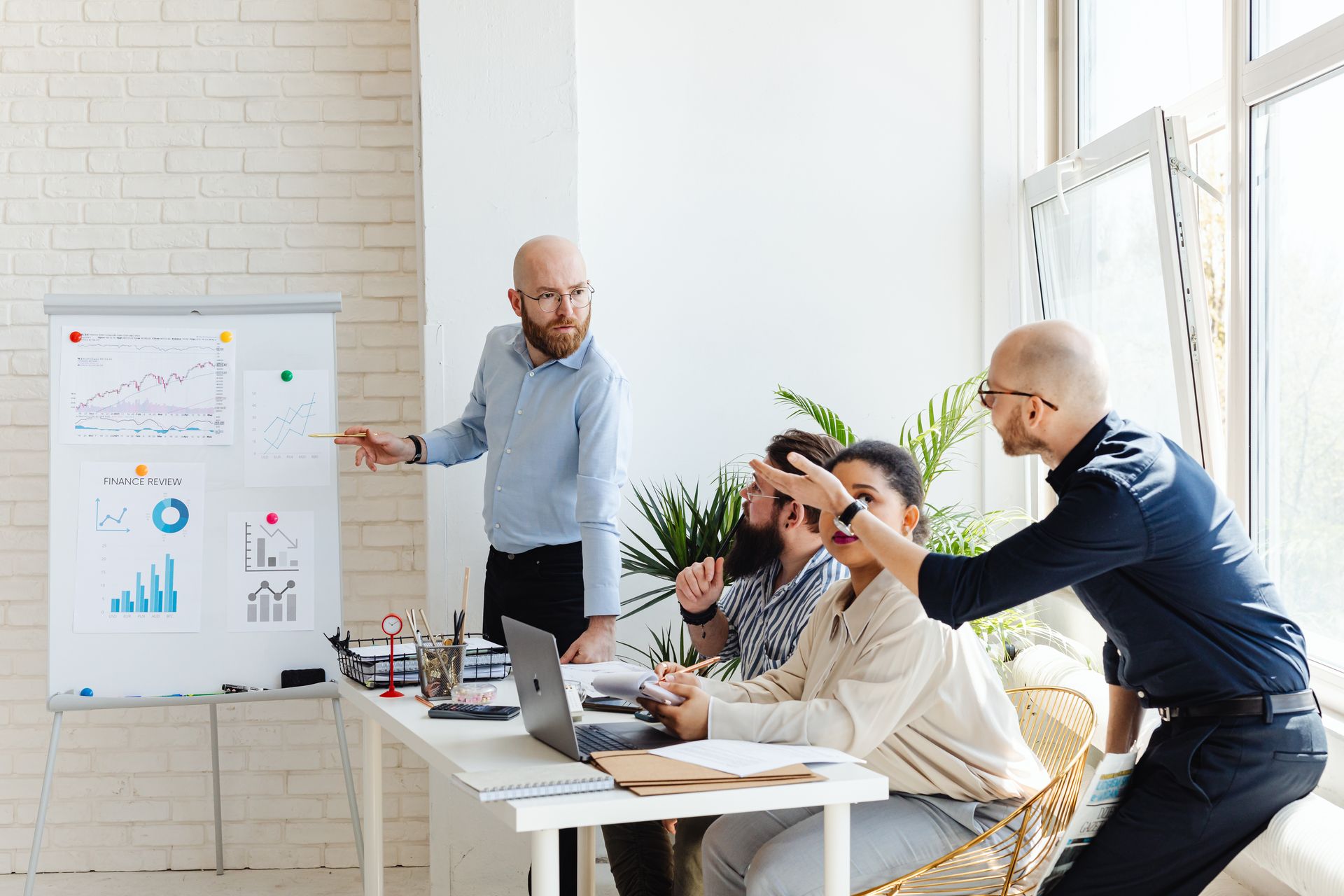 Outsourced financial team reviewing charts during a finance meeting
