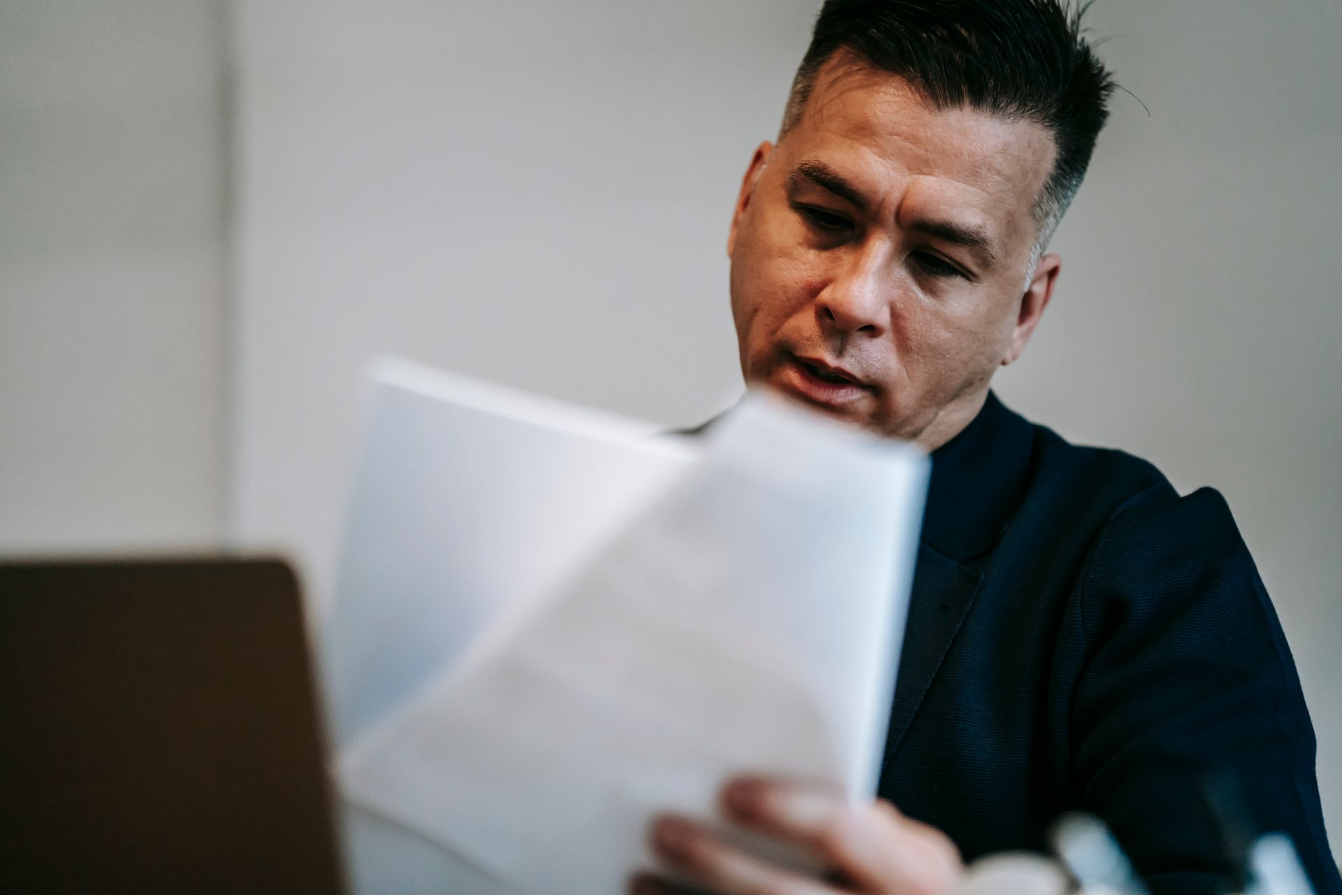Business owner reviewing financial documents for small business bookkeeping