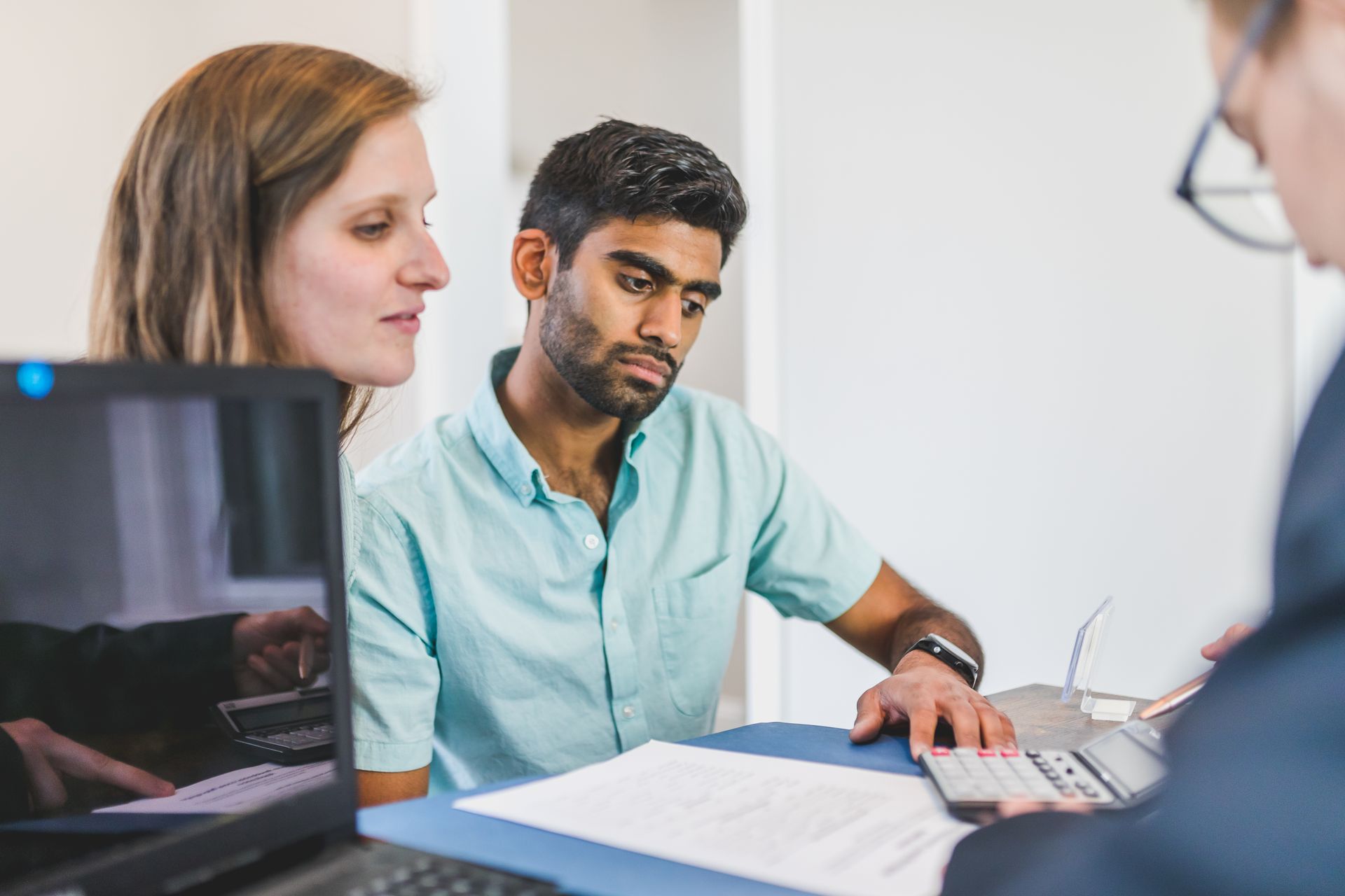 Tax advisor reviewing financial documents with a couple during a planning consultation