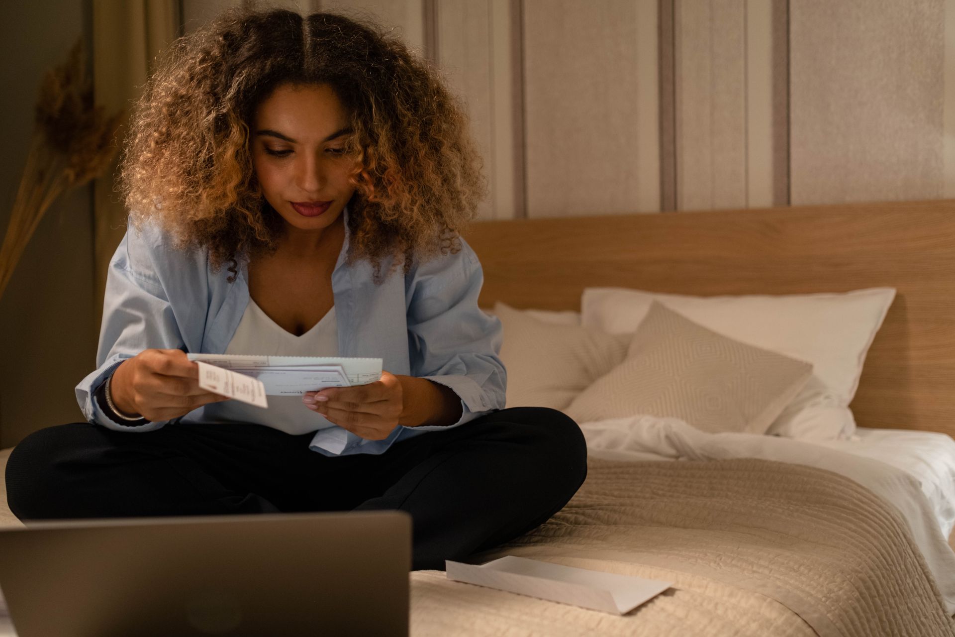 Woman reviewing a CRA document at home about her Canada Recovery Benefit repayment